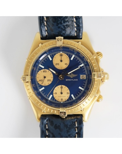 Montre Breitling Chronomat vintage automatique or jaune cadran bleu compteurs dorés bracelet cuir bleu 39mm